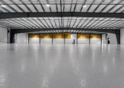 Large warehouse with a glossy gray epoxy floor