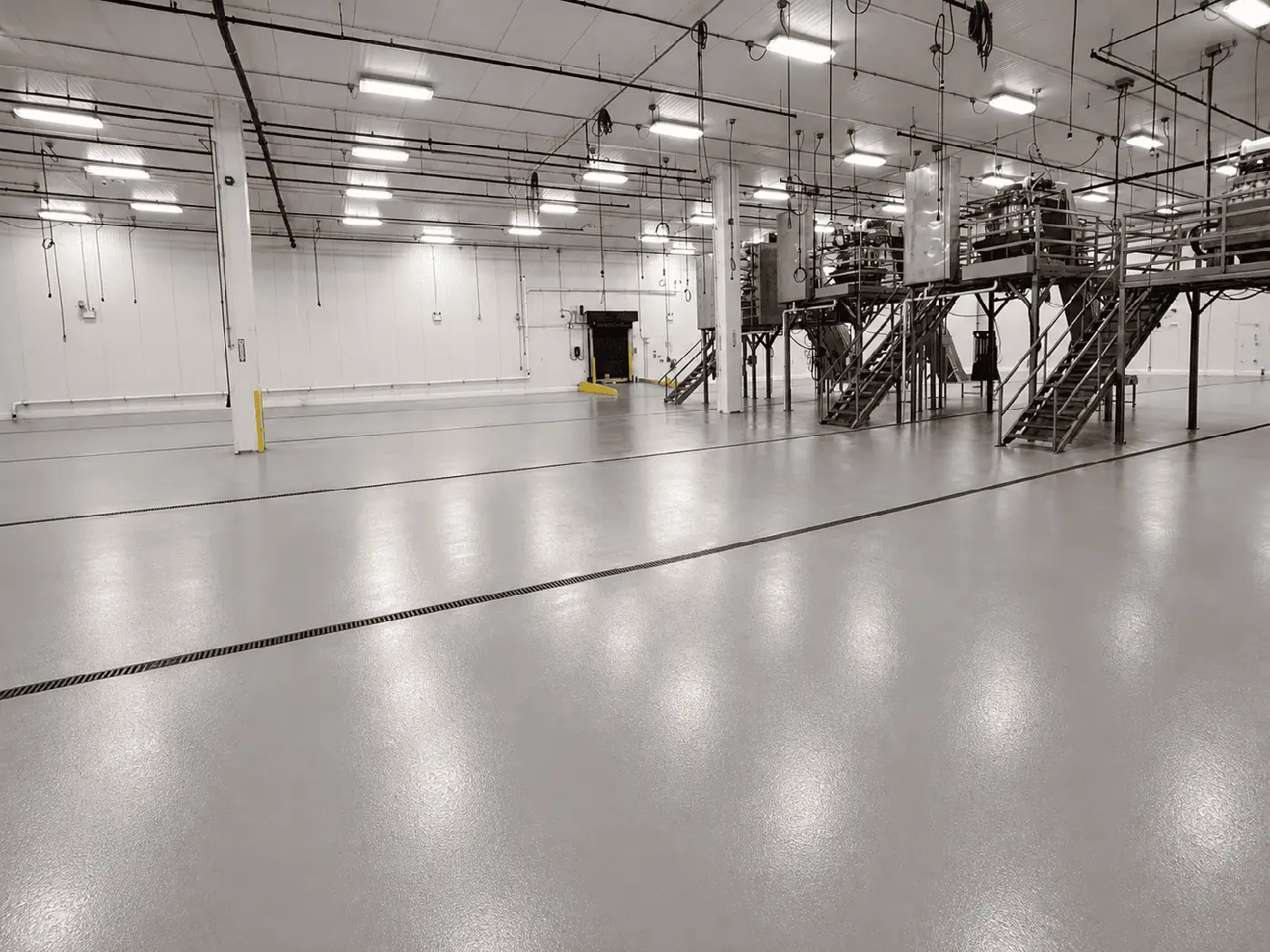 Large warehouse with a glossy gray epoxy floor