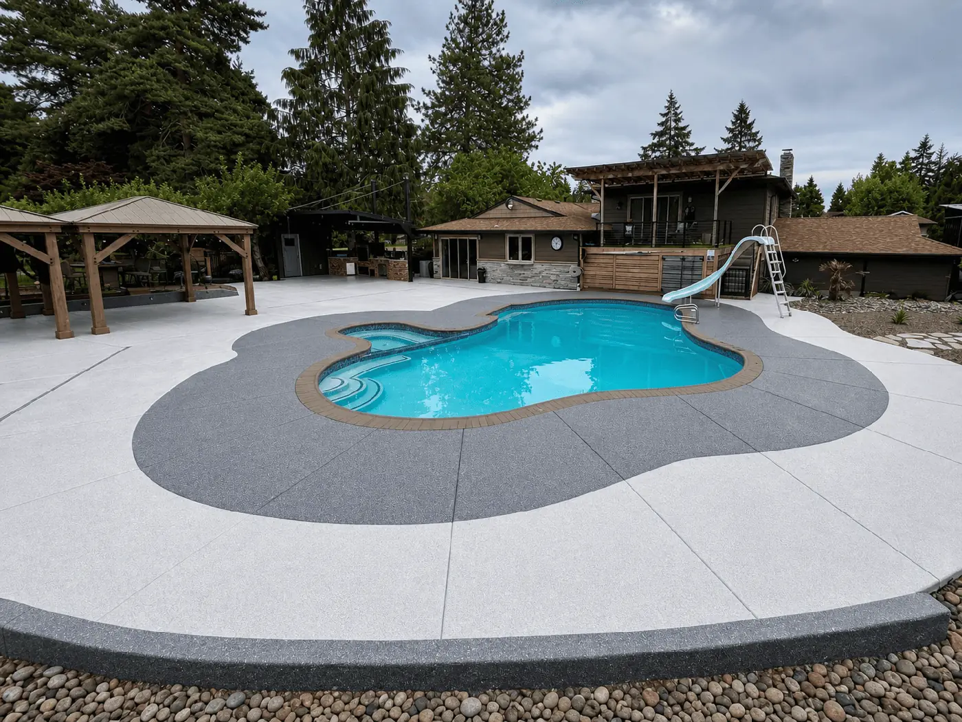 Pool deck with a light gray coating and a darker gray border around the pool