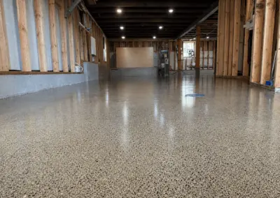 Exposed aggregate floor coating in a commercial space with wood walls