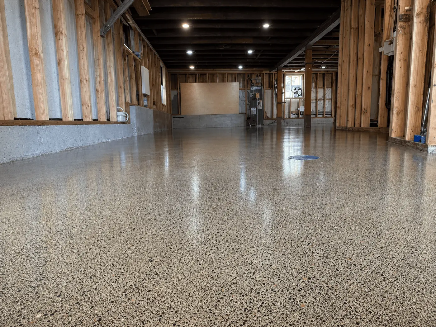 Exposed aggregate floor coating in a commercial space with wood walls