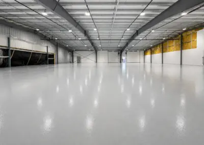 Large warehouse with a glossy gray epoxy floor