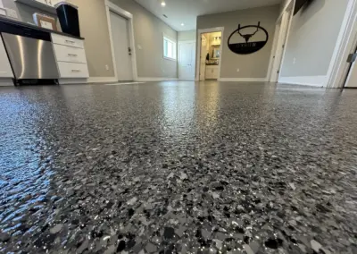 Garage floor with a gray and black polyaspartic flake coating