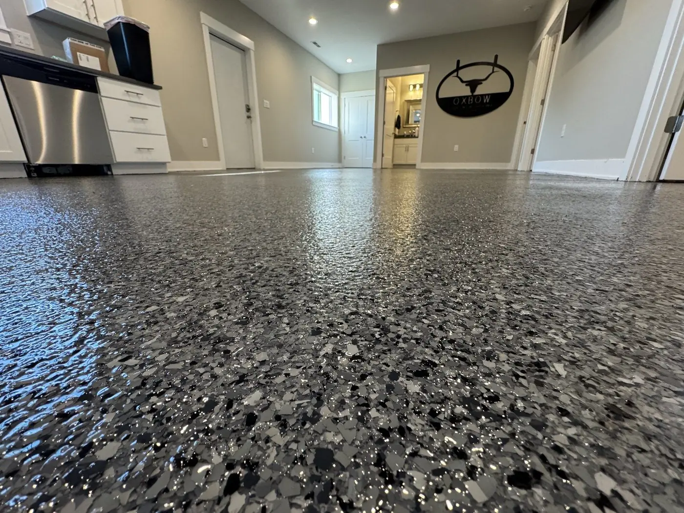 Garage floor with a gray and black polyaspartic flake coating
