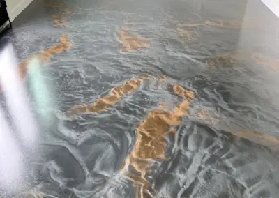Close-up of a metallic epoxy floor with gray and copper swirls