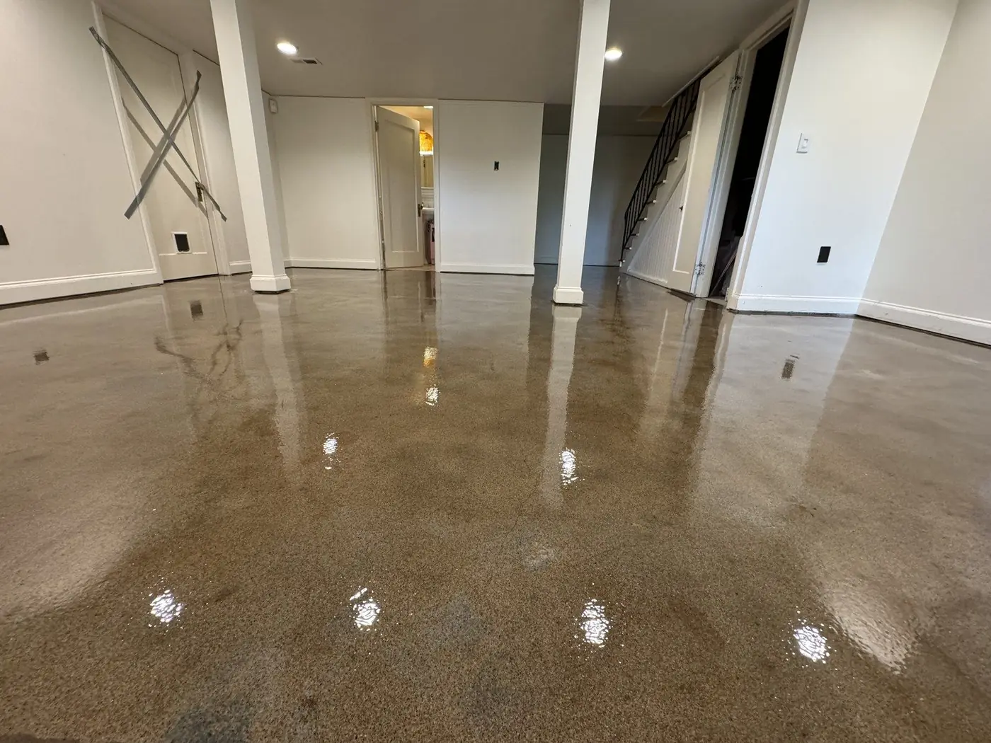 Polished brown concrete floor in a finished basement